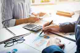 Two professionals reviewing financial documents