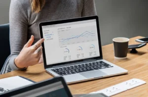 bookkeeper showing a graph on a laptop