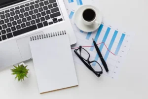 laptop_spiral notebook_glasses_pen_coffee