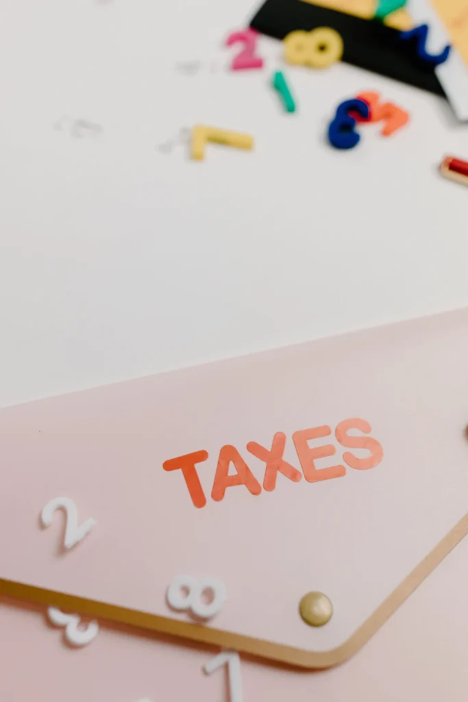 Envelope with taxes stamped on and plastic numbers lying around