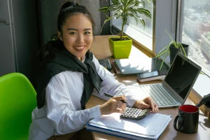Smiling lady working with calculator compressed